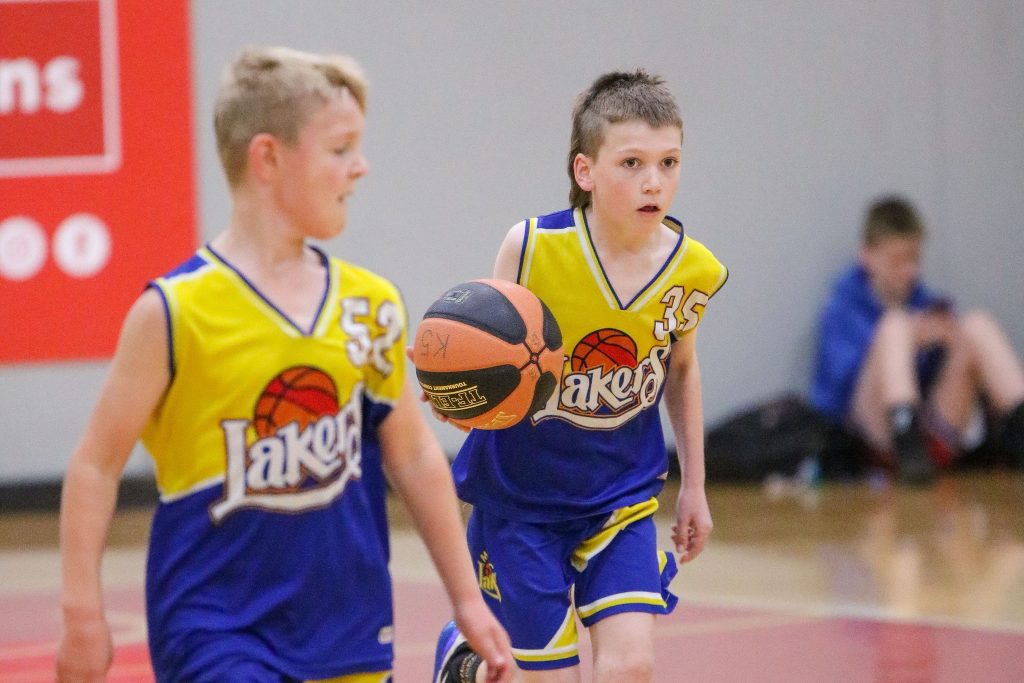 Two Lakers boys players running down the court